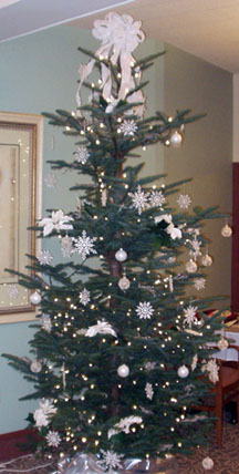A 7 foot high Christmas tree covered with white and gold decorations