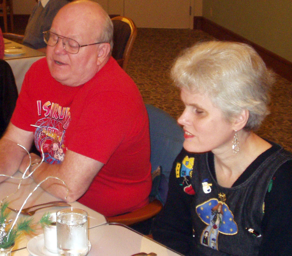 Denise with beautiful angel earrings sitting next to Berl at their table