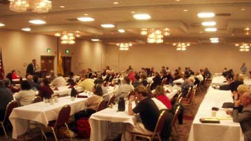 The convention hall filled with seated at rows of tables