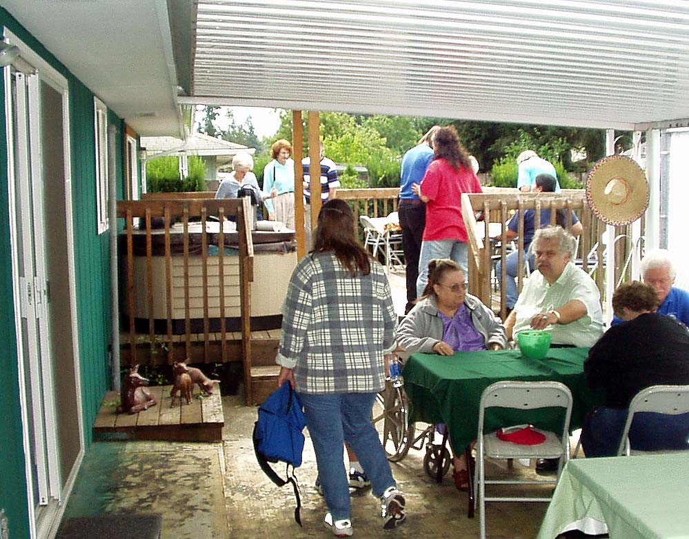 Members and guests gather around tables at Berl's and Denise's house as we get ready to party.