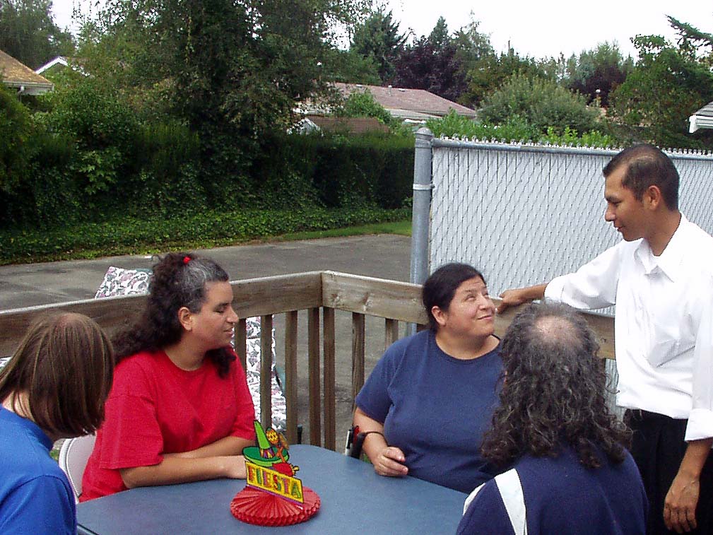 One the right is Elvis, our caterer from El Serape Mexican restaurant, is talking to Viola, Terry, Greg and Gloria