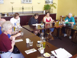 Photo #2 of members and guests sitting around tables