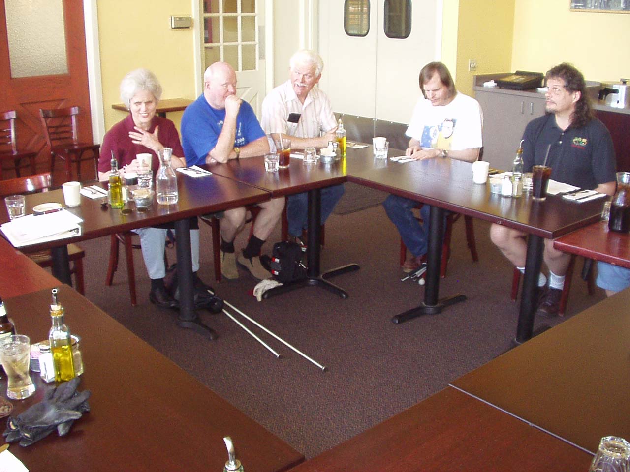 Photo #4 of members and guests sitting around tables.